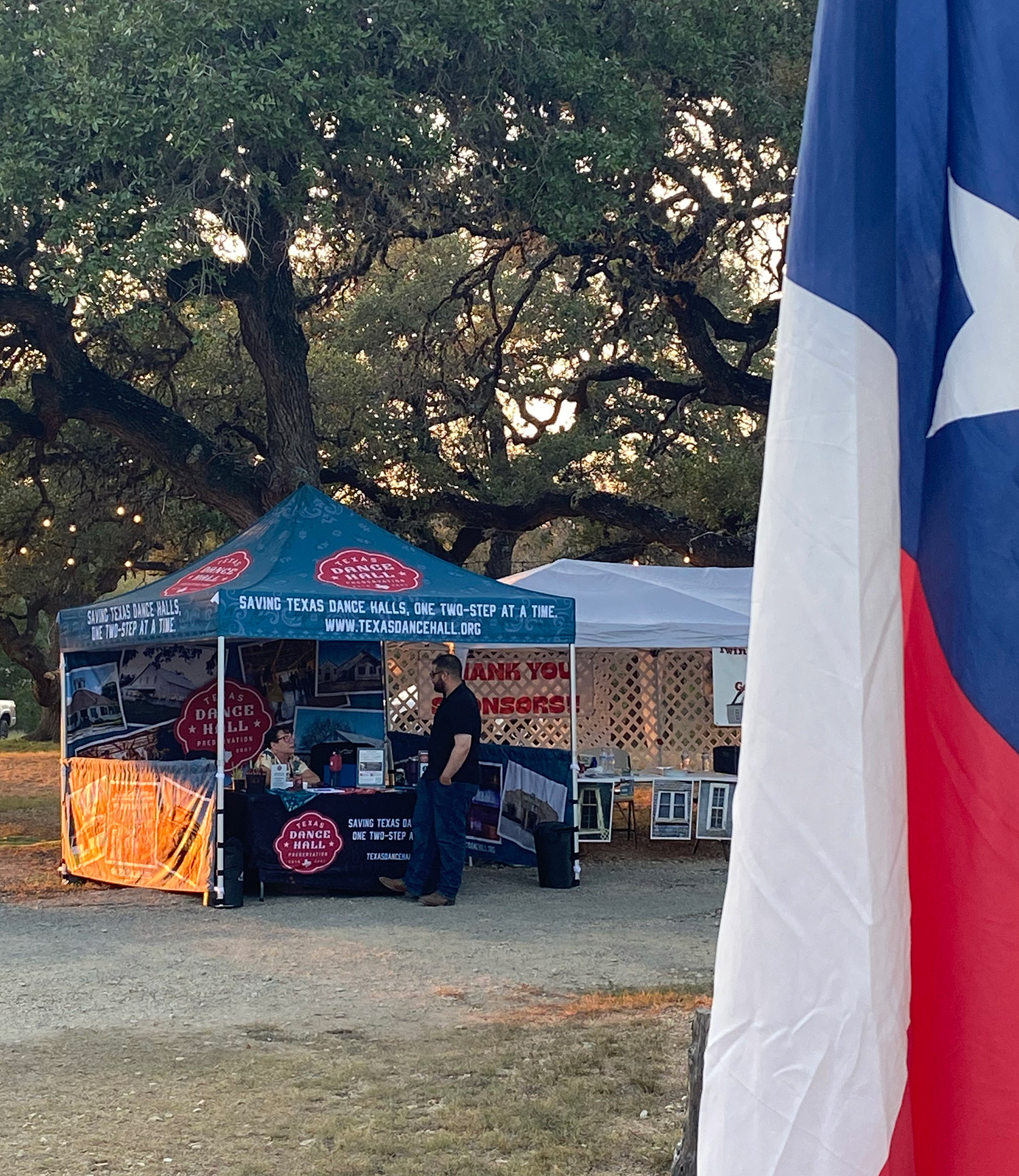 TDHP event tent with a tx flag in the foreground